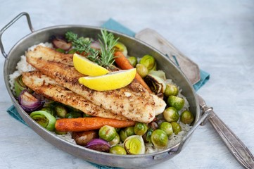 fried fish with rice and vegetables
