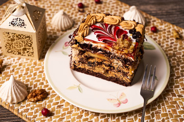 Slice of Chocolate cake with banana, walnut, meringue