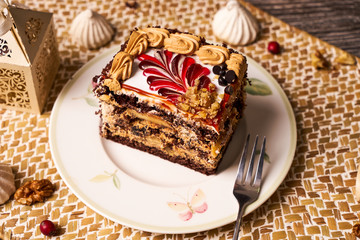Slice of Chocolate cake with banana, walnut, meringue