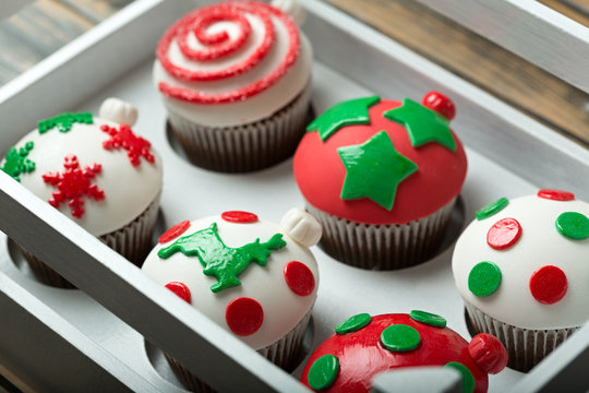 Cupcakes on christmas decorated wooden table