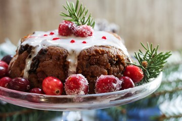 Fototapeta na wymiar Homemade Christmas Pudding cake on festive blue background, selective focus