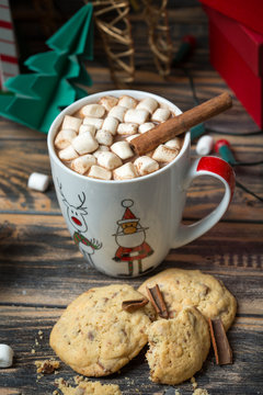 Hot chocolate with marshmallows on christmas decorated wooden table