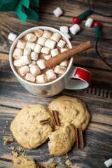 Hot chocolate with marshmallows on christmas decorated wooden table