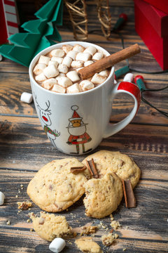 Hot chocolate with marshmallows on christmas decorated wooden table