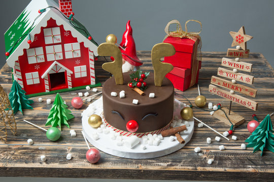 Christmas decorated chocolate cake on wooden table