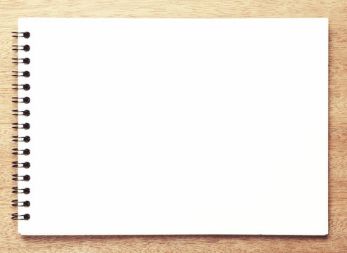 Business essentials. Top view of spiral blank notebook.