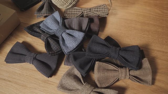 Close-up lots of ready made butterfly bow ties made of wool in the foreground, adds a finished product.