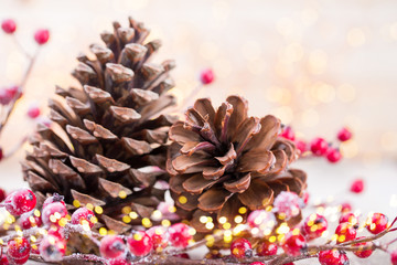 Christmas cone with red berries on a bokeh background.