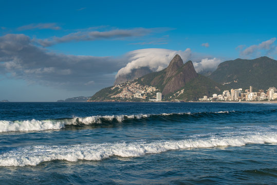 Waves in the Ocean at Ipanema Beach with Beautiful Rio de Janeiro Mountains on Horizon