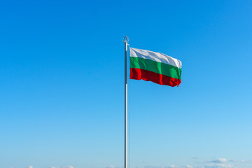 The national flag of Bulgaria against the blue sky.
