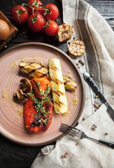 Beautiful serving of vegetables grilled : tomatoes, aubergines, bulgarian pepper and mushrooms with glass of wine