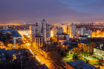 Aerial view of night Voronezh downtown. Voronezh cityscape at blue hour. Urban and traffic lights, houses