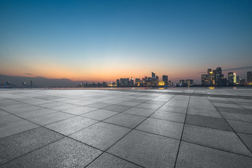 Panoramic skyline and buildings with empty square floor at dusk