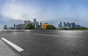 urban traffic road with cityscape in background at twilight, China.