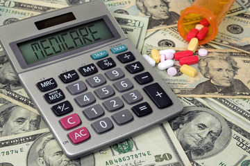 medicare text sign on calculator screen with prescription drugs and pill bottle on American money