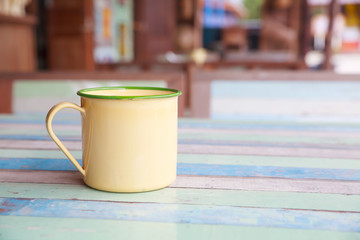 Vintage coffee cup on old wooden table.