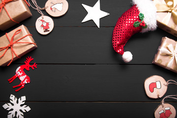 Obraz premium New year's background on a white desk decorated with toys, presents, Santa Claus, snowman. Bright colored background symbolizes the new year celebration. Great useful template to wright words down.
