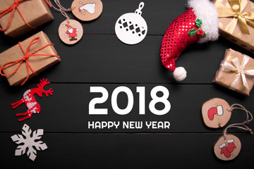 Obraz premium New year's background on a white desk decorated with toys, presents, Santa Claus, snowman. Bright colored background symbolizes the new year celebration. Great useful template to wright words down.