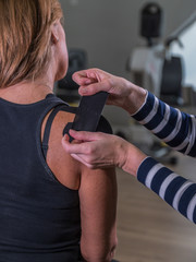 Kinesio-Taping of womans sholder