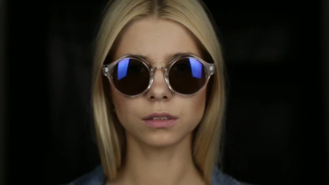Young blond girl in sunglasses