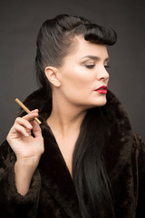 Obraz premium Beautiful lady with cigarette in fur coat. Cyberpunk theme. 