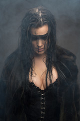 Cyberpunk female with wet hair in fog, painted eye mask