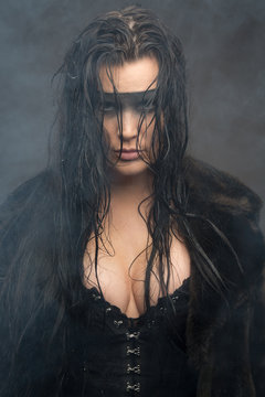 Cyberpunk female with wet hair in fog, painted eye mask