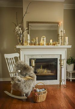 Interior room with elegant Christmas decoration on fireplace, chair  and basket with balls of yarn