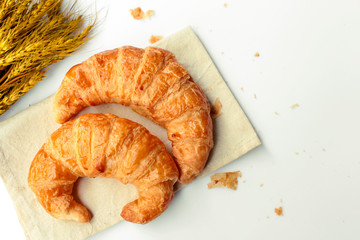 freshly baked croissants on white background, top view