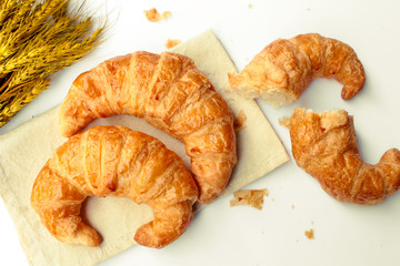 freshly baked croissants on white background, top view