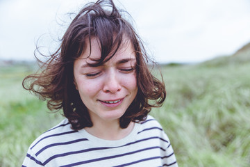 crying girl with disheveled hair outdoor