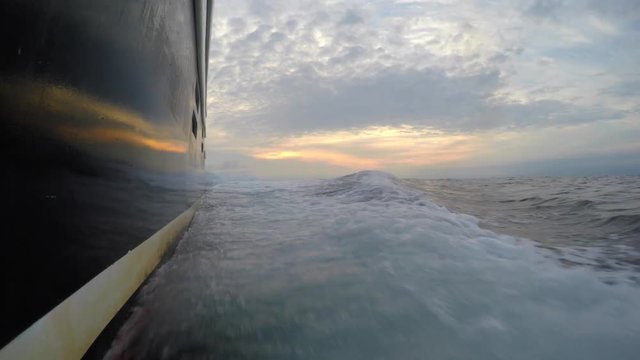 Low shot of a professional fishing boat moving through ocean