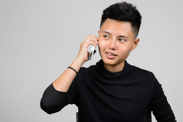 Portrait of Asian young tomboy using mobile phone