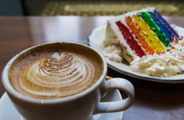 Cappuccino and rainbow cake in a coffeeshop
