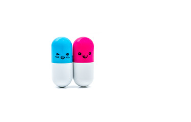 Cute blue and pink couple capsule pills isolated on white background with copy space for text. Global healthcare concept. Taking care of couple life