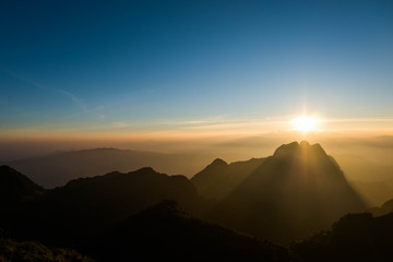 The mountain view and beautiful gold sky in the morning, Thailand. Background and nature concept.