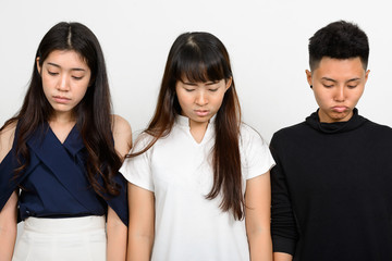 Group Of Three Young Asian Woman Indoors Against White Background