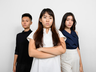 Group Of Three Young Asian Woman Indoors Against White Background