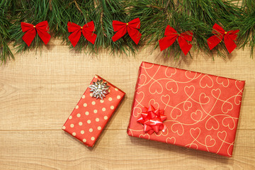 New Year / Christmas gifts in package, tree with red bows on the wooden background template