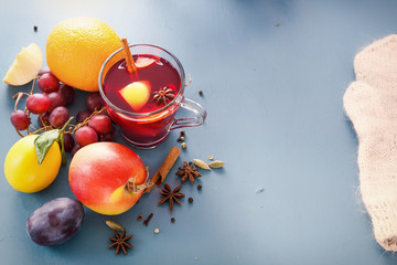 Winter alcoholic drinks - mulled wine, punch, grog. Glass jars with mulled wine. Hot fruit tea. Spices, fruit. Hot wine