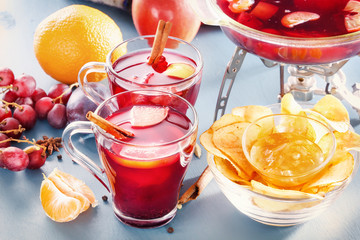 Mull. Glasses with mulled wine, punch or grog with fruit and cornflakes