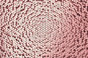 Pattern of red brushed metal cylinders of different length