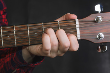  Musician Playing accord Am on acoustic guitar, close up
