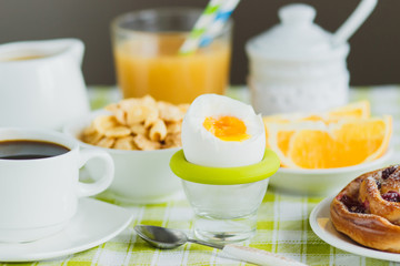 Soft boiled chicken egg, coffee, muesli and orange juice