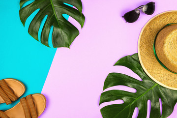 Flatlay with monstera leaves, straw hat and other accessories, summer and holiday concept, copyspace