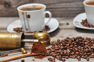 Coffee cup and coffee beans with rustic coffee grinder. 
