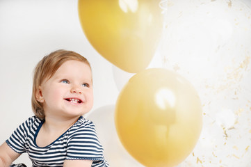 Fototapeta na wymiar Happy and smiling one year old baby portrait with balloon background