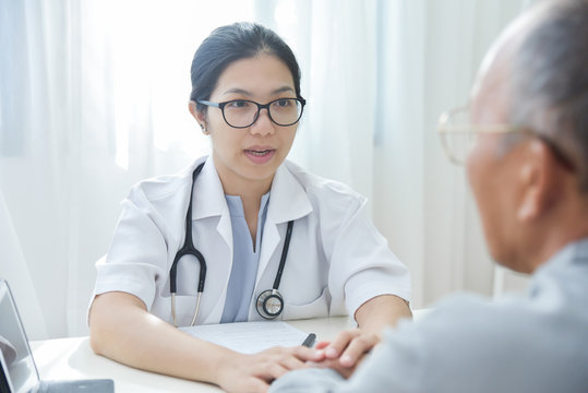 Female Doctor Reassuring Senior Male Patient.