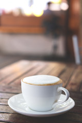 Hot coffee on wooden table