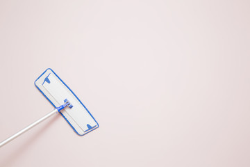 Professional mop on the wall wiping a dust in the room. Regular clean up. Commercial cleaning company concept. Empty place for a text.